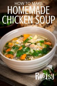 white bowl of homemade chicken soup with vegetables