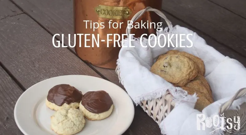 Gluten free cookies on a plate and in a basket in front of a copper cookie jar.