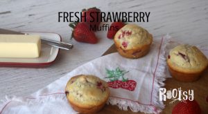 Fresh strawberry muffins on a table with strawberries. Make the most of juicy berries by whipping up these quick and easy fresh strawberry muffins for breakfast and snack time. 