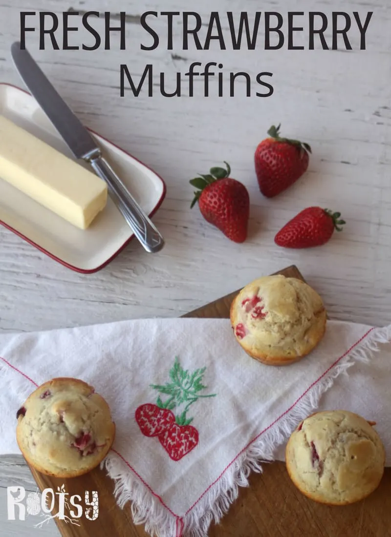 Fresh Strawberry Muffins on a table with butter and strawberries. Make the most of juicy berries by whipping up these quick and easy fresh strawberry muffins for breakfast and snack time. 