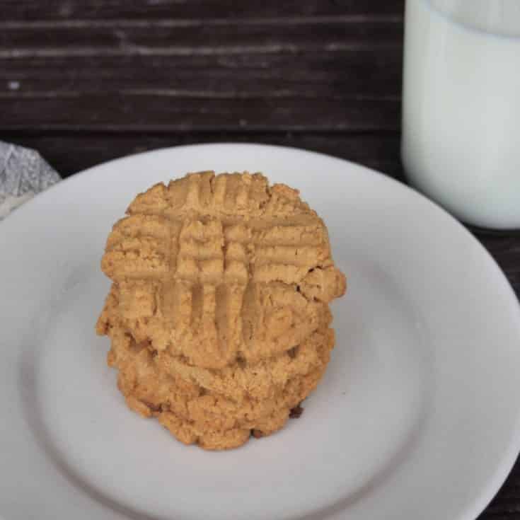Flourless peanut butter cookies stacked on a plate.