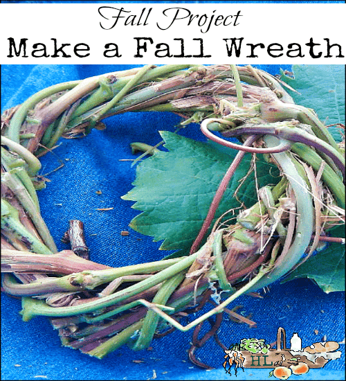 A handmade fall wreath made of twigs and leaves rests on a blue fabric background. Text at the top reads, "Fall Project: Make a Fall Wreath," with decorative autumn-themed illustrations at the bottom, capturing the essence of fall crafts.