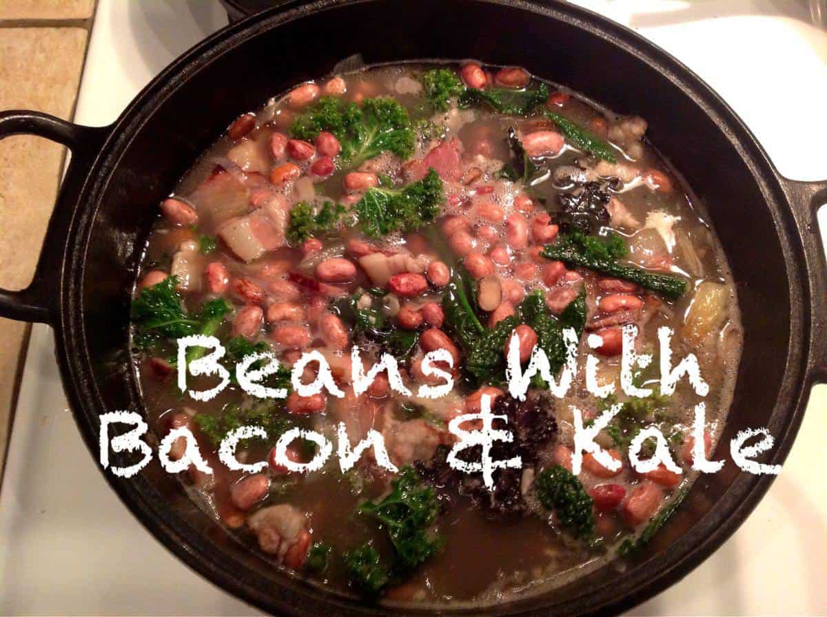 A pot of beans, bacon, and kale simmers in broth on a stovetop. The text "Beans With Bacon & Kale" is overlaid on the image.