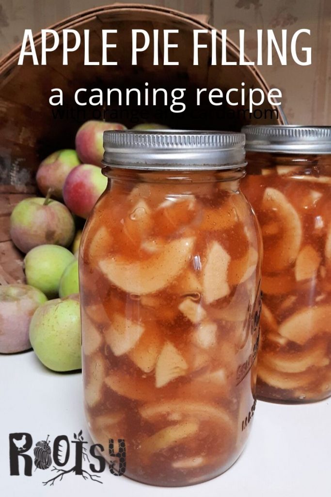 2 jars of canned apple pie filling sitting in front of a basket of fresh apples with text overlay