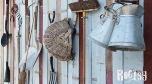 image of garden tools hanging on shed wall for winter