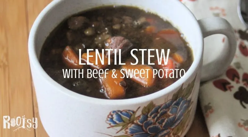 A cup of lentil stew with a napkin and text overly.