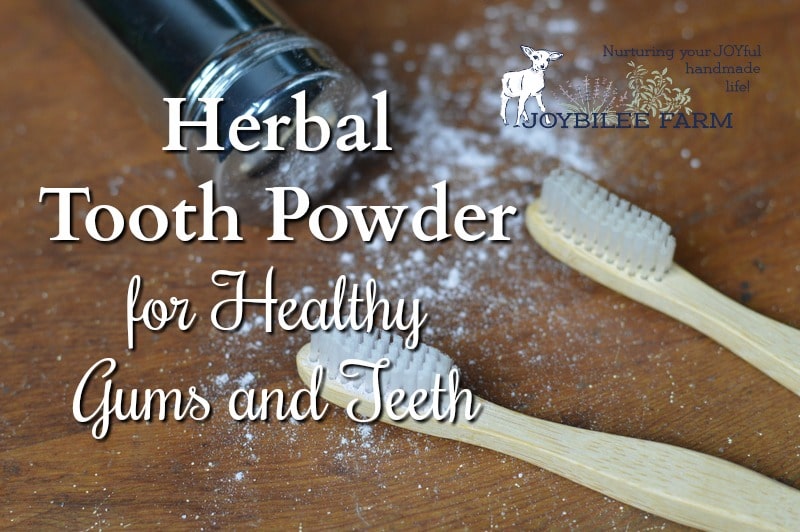 A shaker of herbal tooth powder spills on a wooden surface next to two bamboo toothbrushes, offering a money-saving bathroom solution. Text on the image reads "Herbal Tooth Powder for Healthy Gums and Teeth." A logo for Joybilee Farm is in the top right corner.