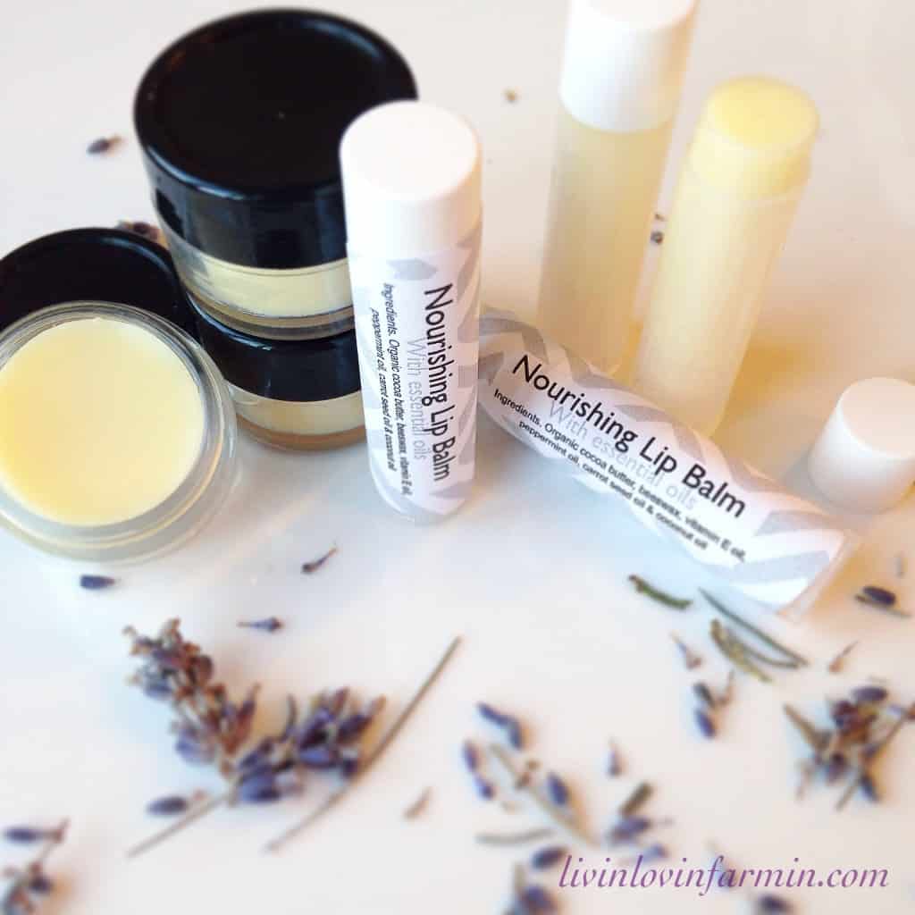 A collection of beauty products, perfect for a money-saving bathroom revamp, including lip balms and small jars of cream, are arranged on a white surface. Dried lavender sprigs are scattered around, with a website URL "livinlovinfarmin.com" visible in the corner.