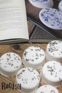 lavender milk bath bombs on wooden table with herbal boom