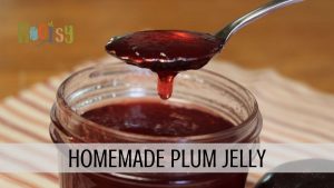 homemade plum jelly dripping off spoon