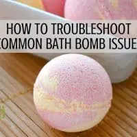 A bath bomb on a bamboo mat with text overlay reading: how to troubleshoot common bath bomb issues.