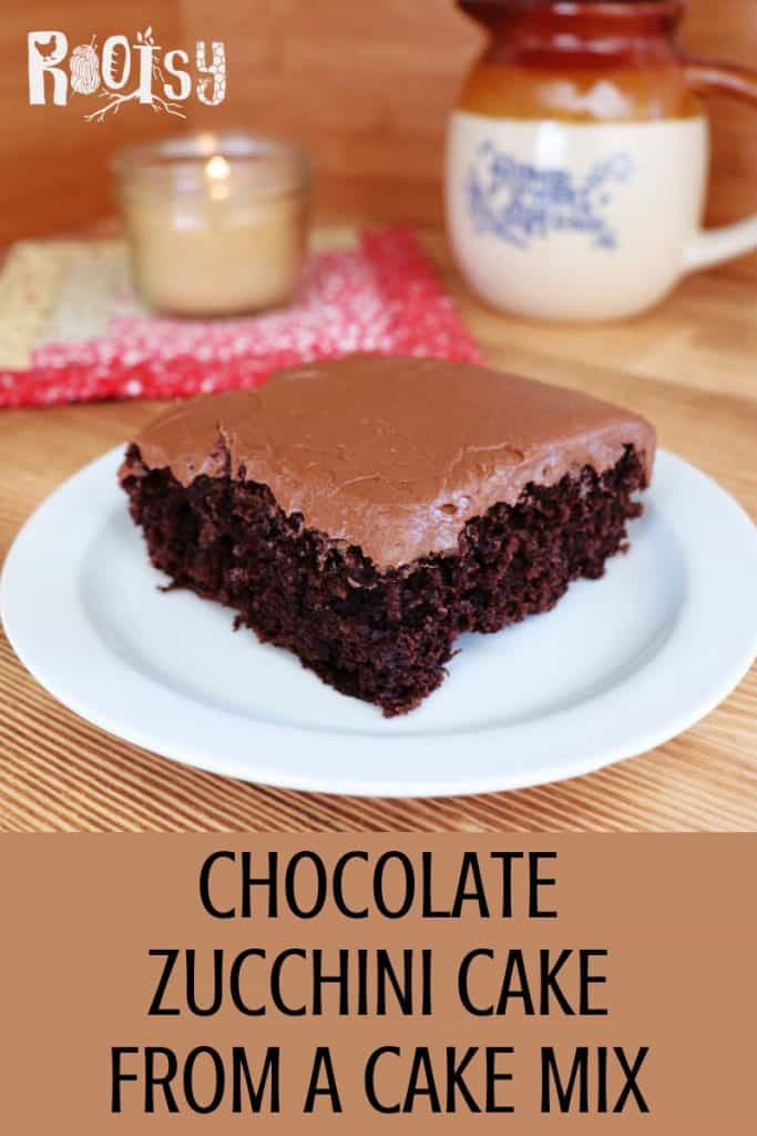A slice of chocolate zucchini cake with chocolate frosting sits on a white plate. In the background are a candle, a mug, and a red-patterned napkin. Text below reads: "Chocolate Zucchini Cake From a Cake Mix.